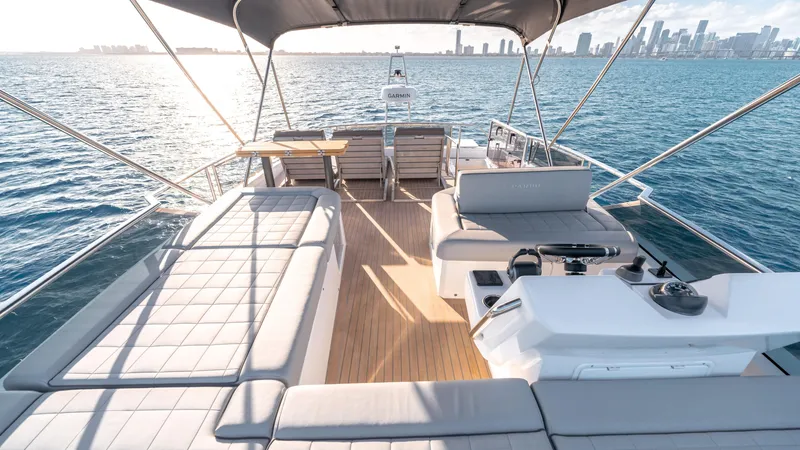 Slide: The Image of Luxurious 2024 Pardo Yachts E60 with spacious deck, ocean view, and city skyline in background. - 26