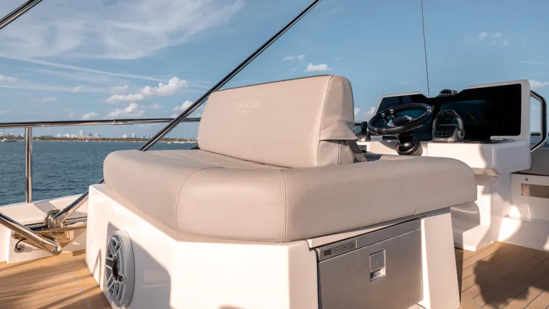 Slide: The Image of 2024 Pardo Yachts E60 helm seat with ocean view and modern controls. - 28