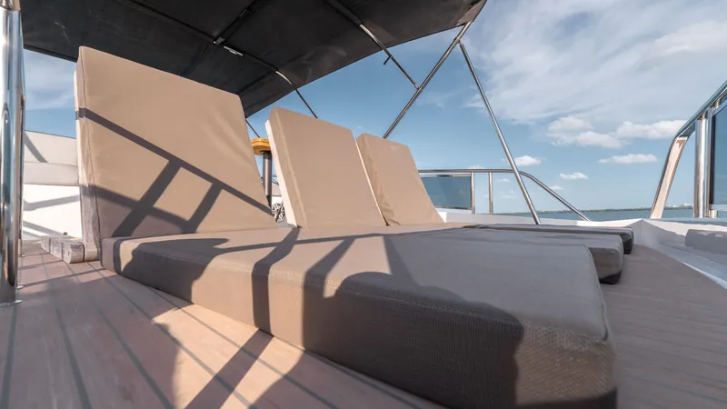 Slide: The Image of 2024 Pardo Yachts E60 sun deck with cushioned loungers under a canopy. - 31