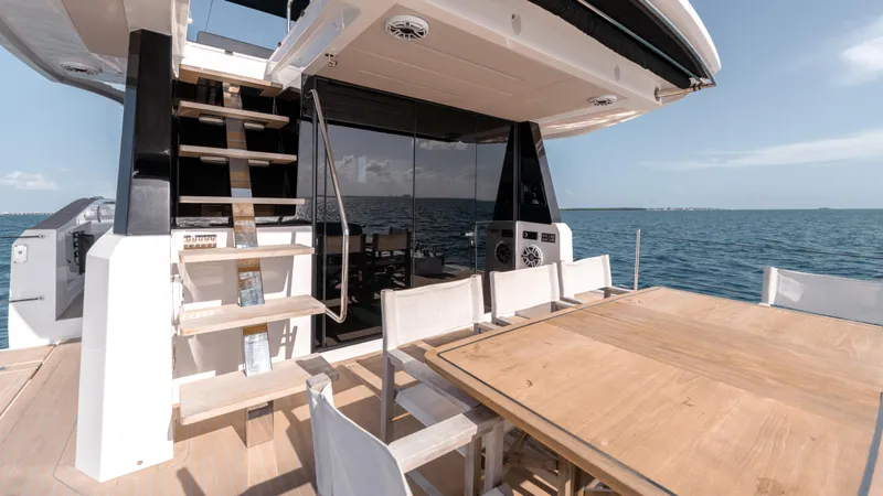Slide: The Image of 2024 Pardo Yachts E60 deck with dining area and ocean view. - 35