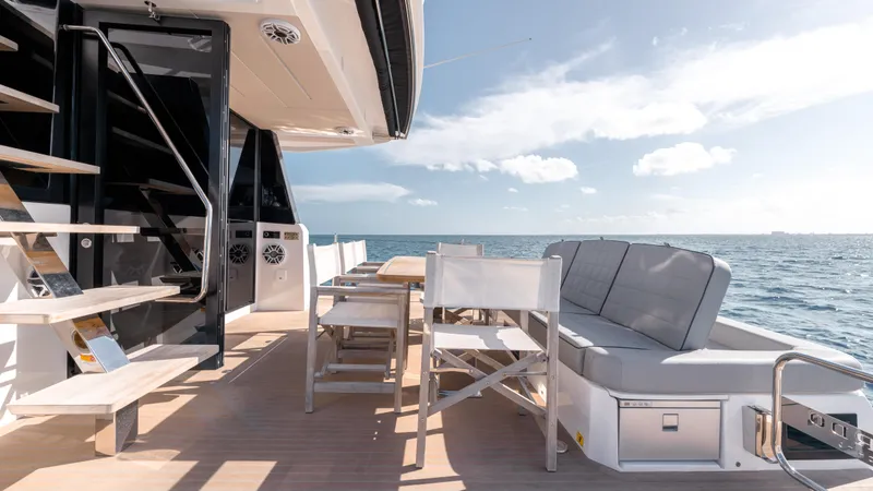 Slide: The Image of 2024 Pardo Yachts E60 deck with seating, table, and ocean view. - 39