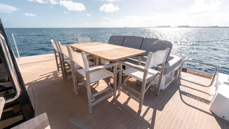 Slide: The Image of Luxury outdoor dining area on 2024 Pardo Yachts E60, overlooking the ocean. - 41