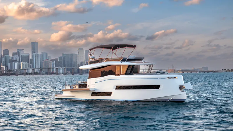 Slide: The Image of 2024 Pardo Yachts E60 cruising near city skyline at sunset. - 6