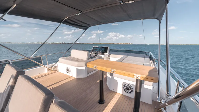 Slide: The Image of 2024 Pardo Yachts E60 deck with seating and table, overlooking the ocean. - 27