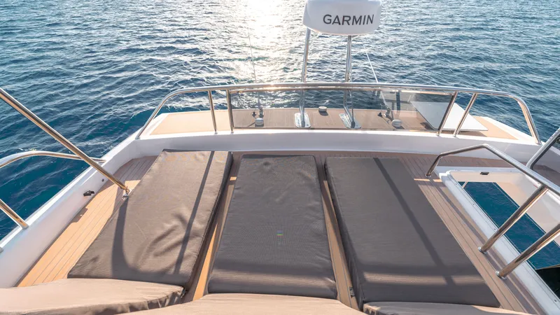 Slide: The Image of 2024 Pardo Yachts E60 deck with sun loungers and Garmin radar, overlooking the ocean. - 32
