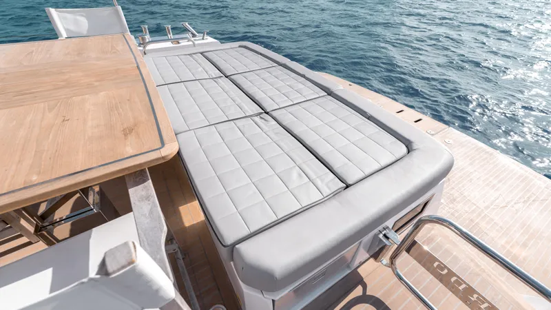 Slide: The Image of 2024 Pardo Yachts E60 deck with sunbed and dining area by the sea. - 44