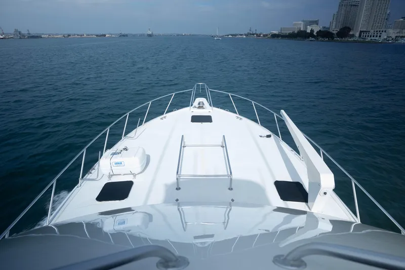 Slide: The Image of Bow view of 1990 Hatteras 58 Convertible yacht cruising in open water. - 10