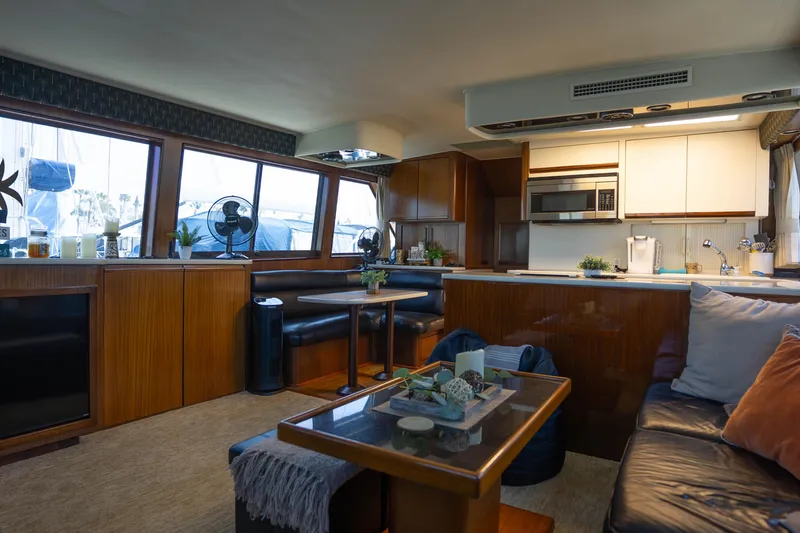 Slide: The Image of Luxurious interior of 1990 Hatteras 58 Convertible yacht with modern kitchen and seating area. - 18