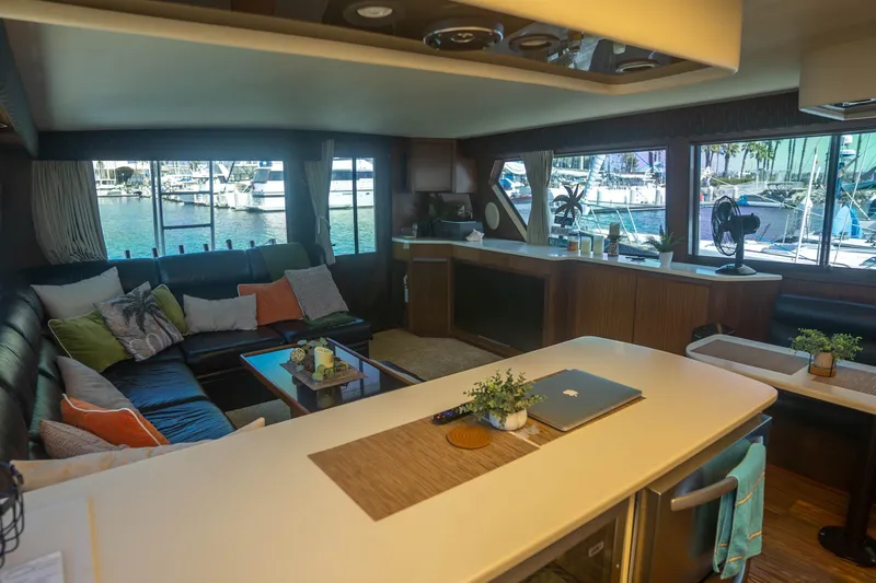 Slide: The Image of Luxurious interior of 1990 Hatteras 58 Convertible yacht with marina view. - 22
