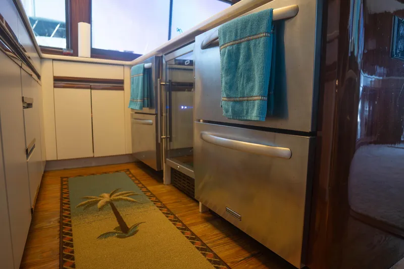 Slide: The Image of Luxurious kitchen interior of 1990 Hatteras 58 Convertible yacht with modern appliances. - 23
