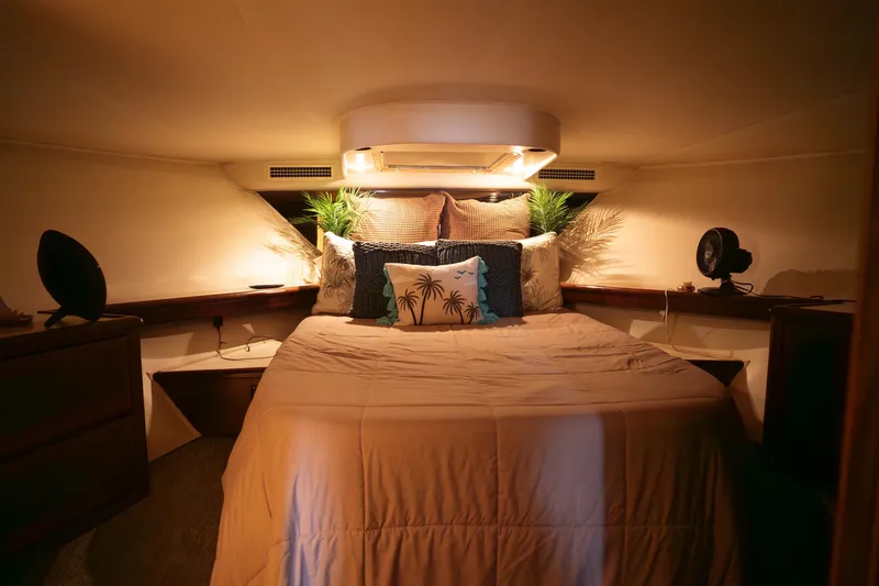Slide: The Image of Cozy bedroom interior of 1990 Hatteras 58 Convertible yacht with elegant decor. - 28