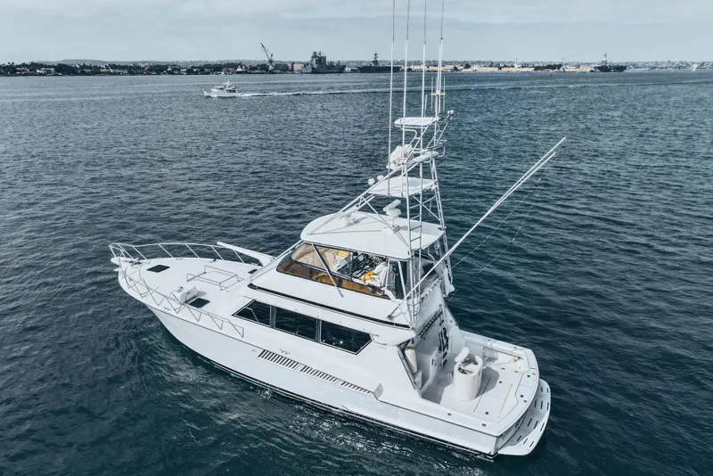 Slide: The Image of 1990 Hatteras 58 Convertible yacht cruising on open water. - 3