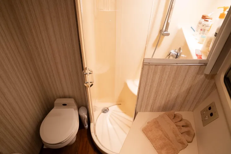 Slide: The Image of Bathroom interior of 1990 Hatteras 58 Convertible yacht with shower and toilet. - 31