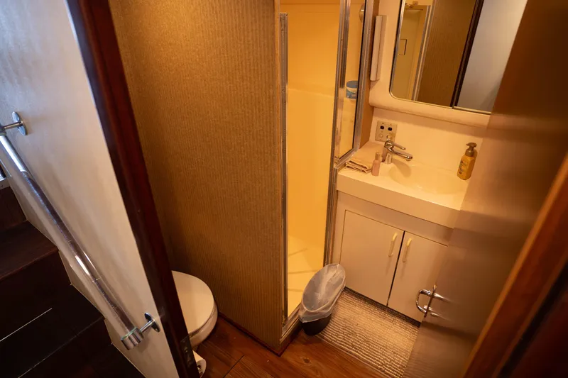 Slide: The Image of Bathroom interior of 1990 Hatteras 58 Convertible yacht, featuring sink, toilet, and shower. - 35