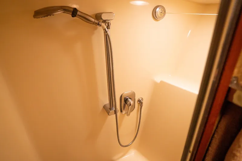 Slide: The Image of Shower area in 1990 Hatteras 58 Convertible yacht, featuring modern fixtures. - 36