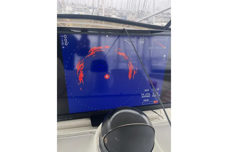 Slide: The Image of Radar display on 1990 Hatteras 58 Convertible boat, showing navigation data. - 46