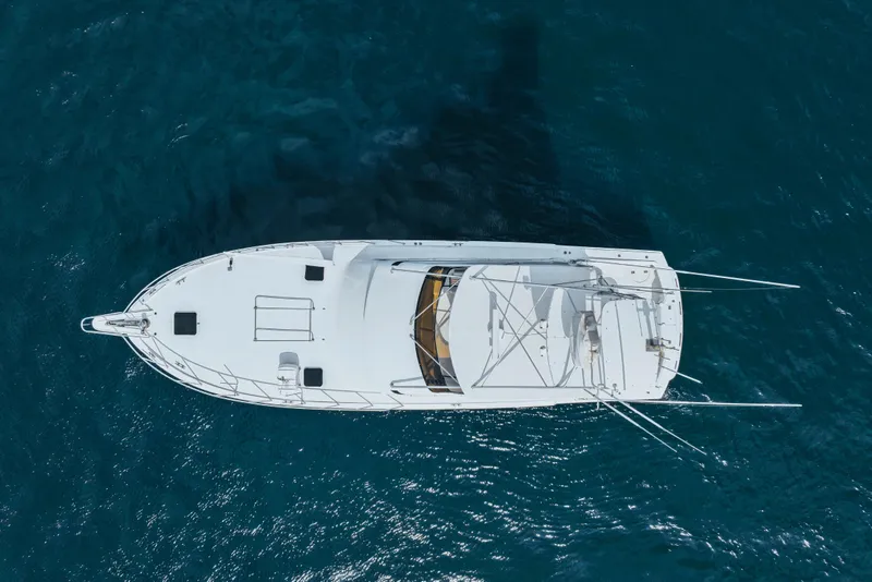 Slide: The Image of Aerial view of 1990 Hatteras 58 Convertible yacht on blue ocean water. - 6