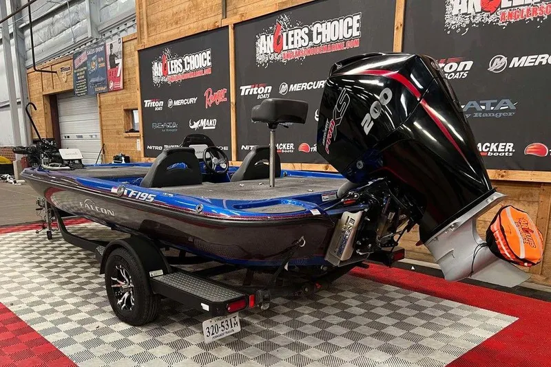 Slide: The Image of 2019 Falcon F195 boat with 200 HP engine on display indoors. - 2