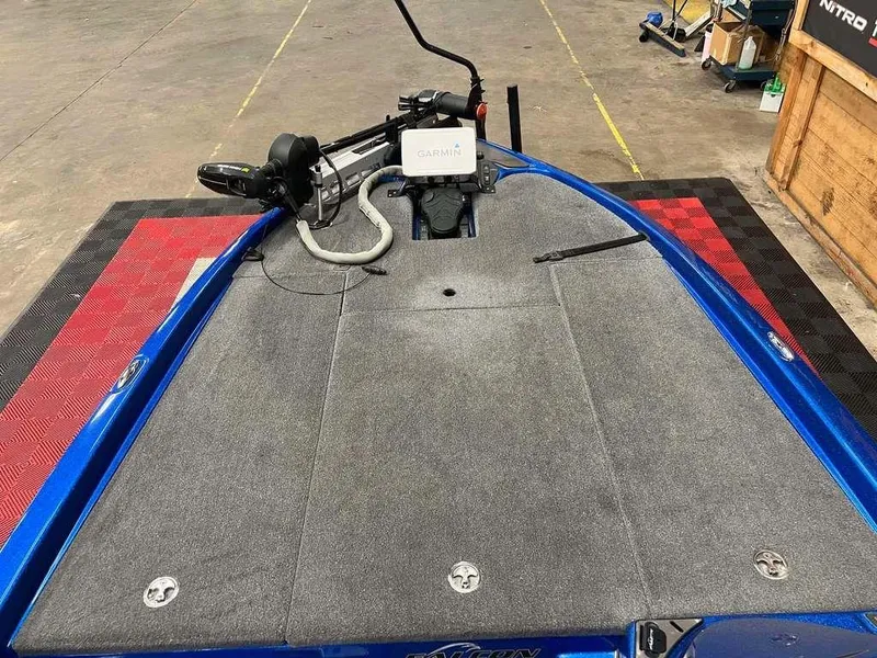 Slide: The Image of 2019 Falcon F195 boat deck with gray carpet and mounted equipment. - 4
