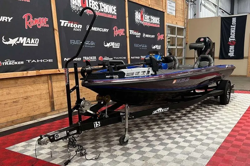 Slide: The Image of 2019 Falcon F195 boat on display in a showroom with branded banners. - 5