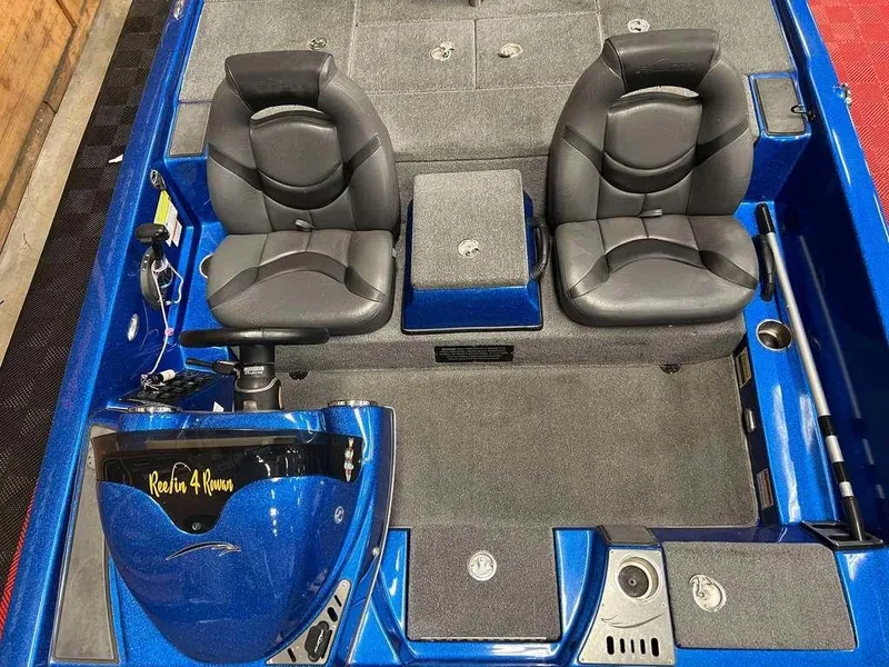 Slide: The Image of 2019 Falcon F195 boat interior with dual seats and blue accents. - 6