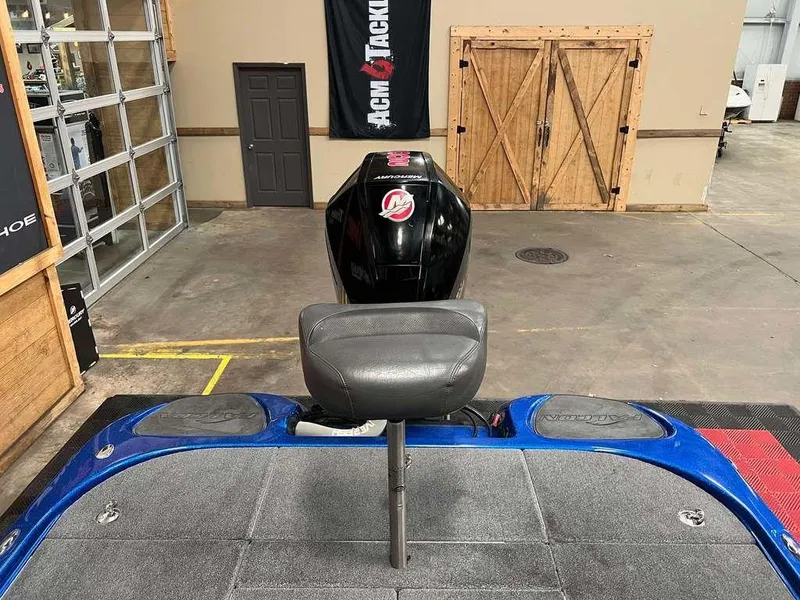 Slide: The Image of Blue Falcon F195 boat interior with seat and motor, in a showroom setting. - 8