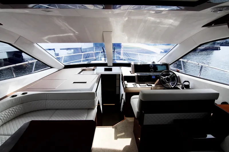 Slide: The Image of Luxurious interior of 2020 Galeon 550 Fly yacht with modern helm and seating. - 11