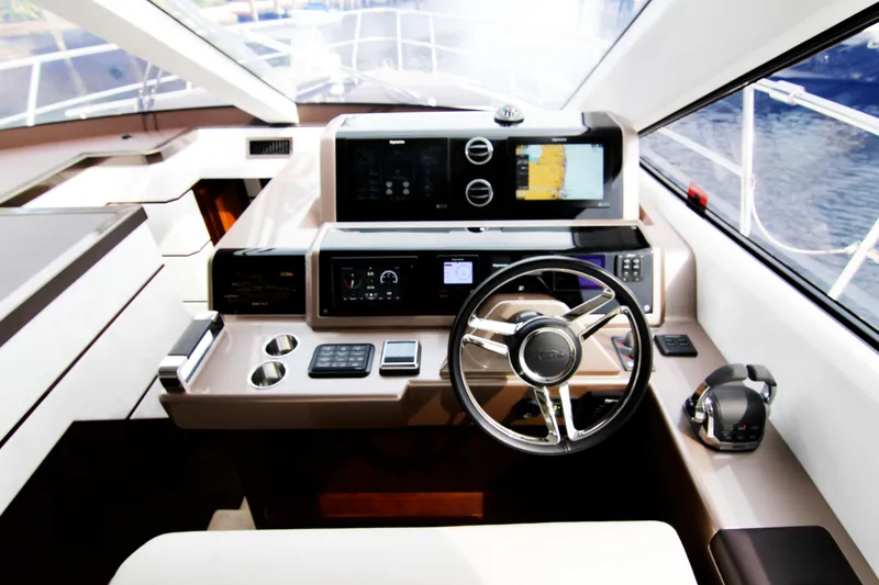 Slide: The Image of Helm of 2020 Galeon 550 Fly yacht with modern navigation equipment and steering wheel. - 15