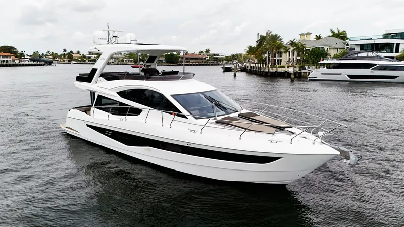 Slide: The Image of 2020 Galeon 550 Fly yacht cruising on a calm waterway with modern design. - 4