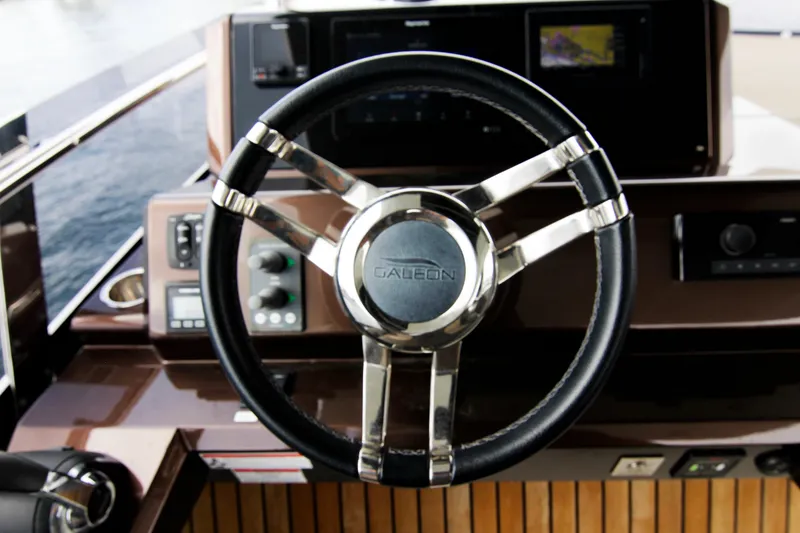 Slide: The Image of Steering wheel of 2020 Galeon 550 Fly yacht, featuring modern controls and sleek design. - 47