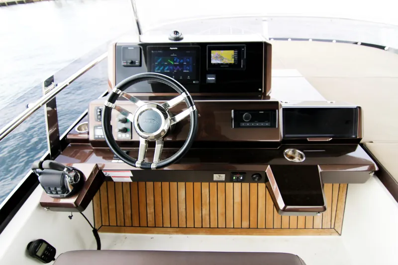 Slide: The Image of Helm of 2020 Galeon 550 Fly yacht with modern navigation controls. - 48