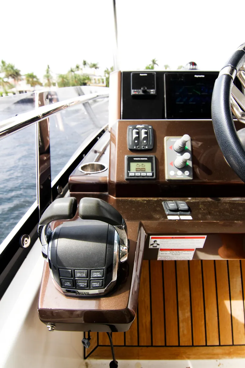 Slide: The Image of Control panel of 2020 Galeon 550 Fly yacht with steering wheel and navigation controls. - 49