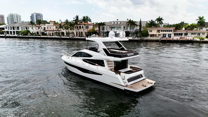 Slide: The Image of 2020 Galeon 550 Fly yacht cruising near waterfront homes. - 7