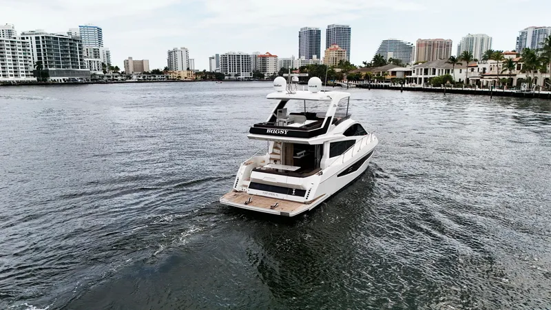 Slide: The Image of 2020 Galeon 550 Fly yacht cruising in a city waterfront with skyscrapers. - 9