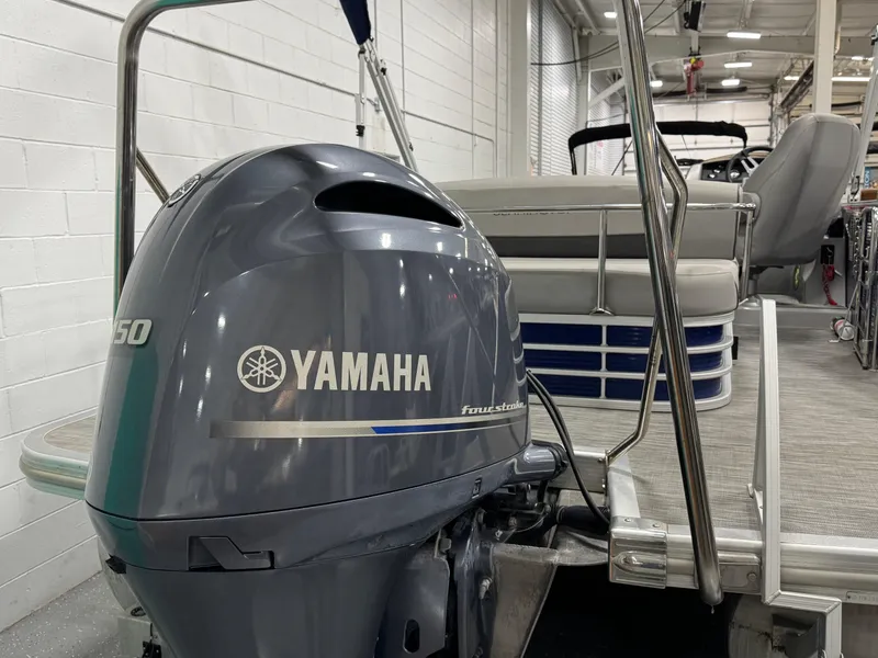 Slide: The Image of 2020 Bennington SXP 23 SSBXP pontoon boat with Yamaha outboard motor in a showroom. - 13