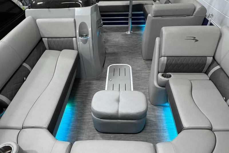 Slide: The Image of 2020 Bennington SXP 23 SSBXP pontoon boat interior with gray seating and blue LED lighting. - 22