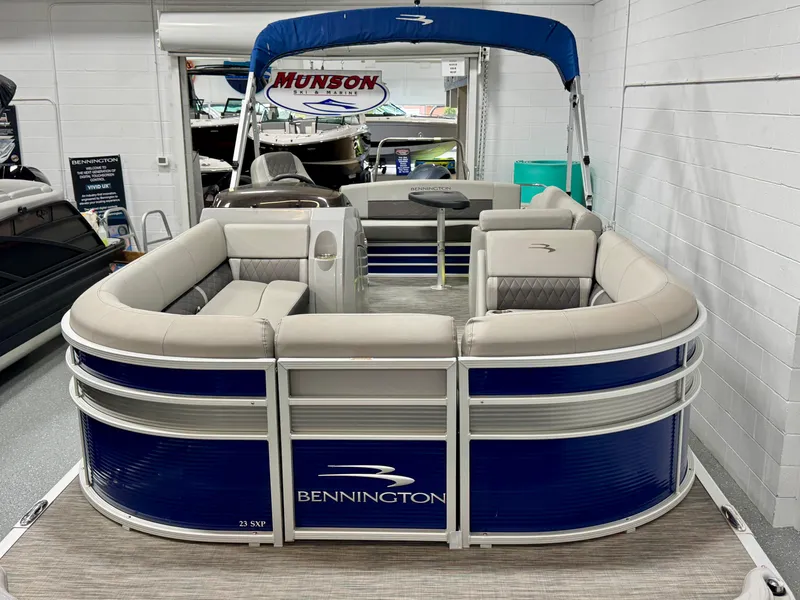 Slide: The Image of 2020 Bennington SXP 23 SSBXP pontoon boat with blue and beige seating in showroom. - 4