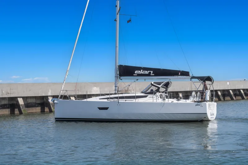 Slide: The Image of 2017 Elan E4 sailboat docked in calm waters under a clear blue sky. - 0
