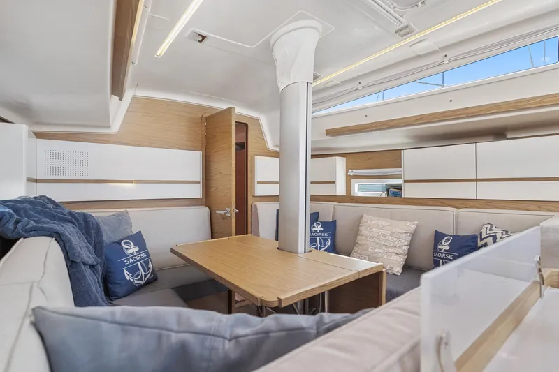 Slide: The Image of Interior of 2017 Elan E4 yacht with modern seating and wooden table. - 1