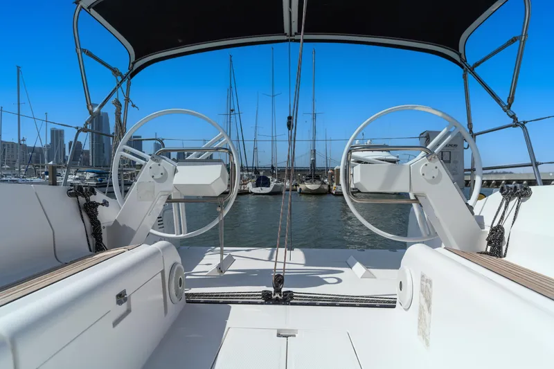 Slide: The Image of Sailboat cockpit view with dual steering wheels, Elan E4 2017, marina background. - 11