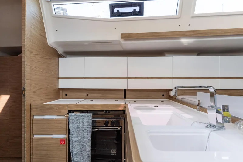 Slide: The Image of Modern kitchen interior of 2017 Elan E4 yacht with sleek cabinetry and appliances. - 13