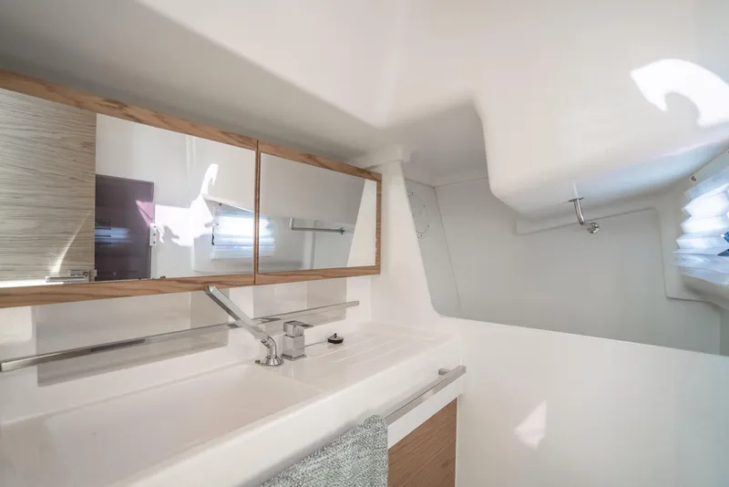 Slide: The Image of Modern bathroom interior in 2017 Elan E4 yacht, featuring sleek design and ample lighting. - 19