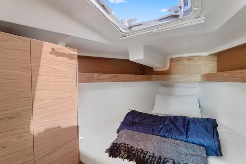 Slide: The Image of Cozy cabin interior of 2017 Elan E4 yacht with skylight and bedding. - 22