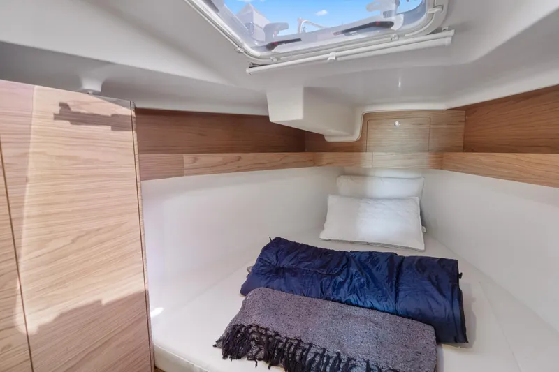 Slide: The Image of Cozy cabin interior of 2017 Elan E4 yacht with bedding and natural light. - 23