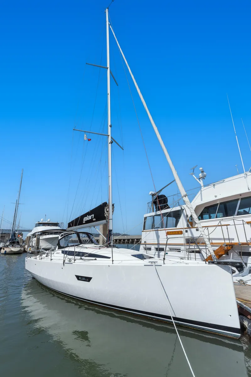 Slide: The Image of 2017 Elan E4 sailboat docked in a marina under a clear blue sky. - 26