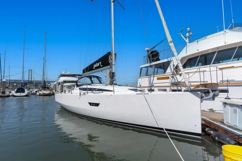 Slide: The Image of Sleek 2017 Elan E4 sailboat docked in a marina under clear blue skies. - 29