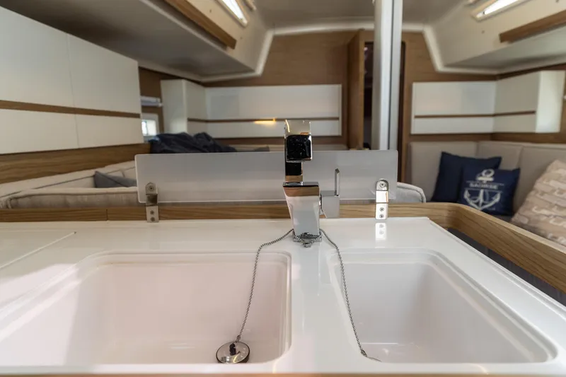 Slide: The Image of Modern kitchen sink in 2017 Elan E4 yacht interior, featuring sleek design and nautical decor. - 32