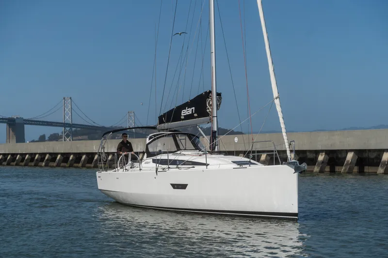 Slide: The Image of 2017 Elan E4 sailboat cruising near a bridge on a sunny day. - 36