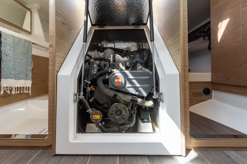 Slide: The Image of Engine compartment of a 2017 Elan E4 sailboat, showcasing the engine and interior design. - 37