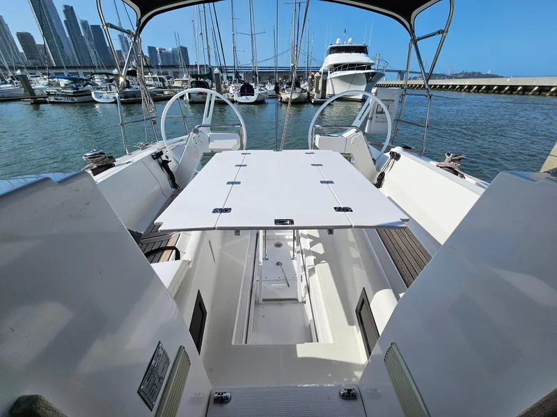 Slide: The Image of 2017 Elan E4 yacht cockpit with dual steering wheels, docked in a marina. - 38